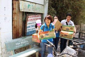 A photo of PEB Steel employees happily delivering charity items at Cu Chi Home Of Blind.