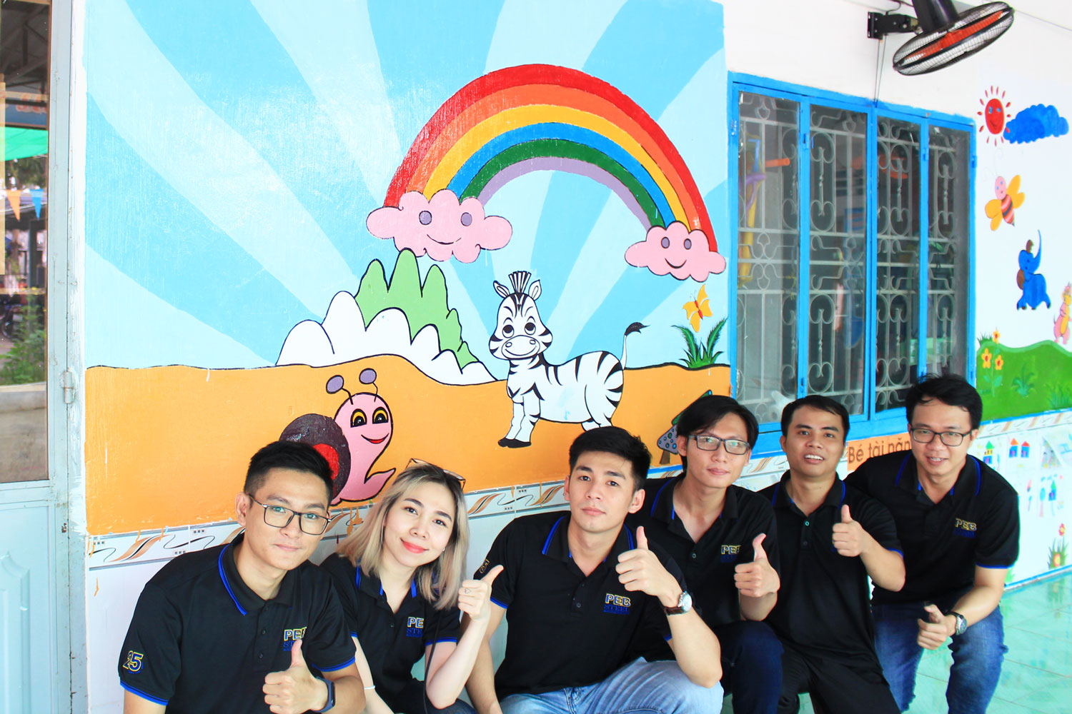 PEB Staff helped the teachers paint the classroom walls with colorful pictures.